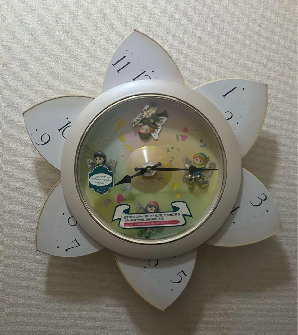 Small World 花の形状 掛時計 動く人形付き