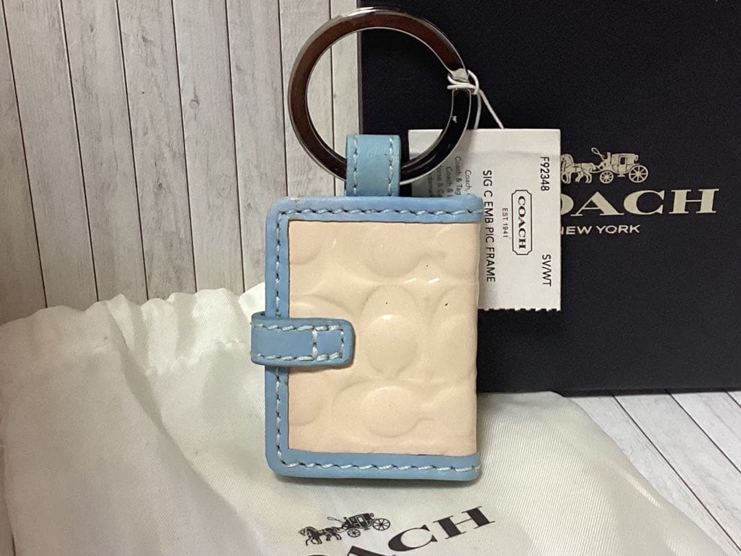 未使用タグ付きCOACH 水色キーホルダーSLC EMB R/C FRAME本物